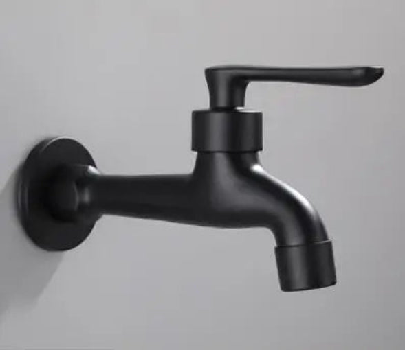 Black faucet mounted on a light gray wall