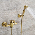 Gold shower set with handheld shower head on a stone wall background