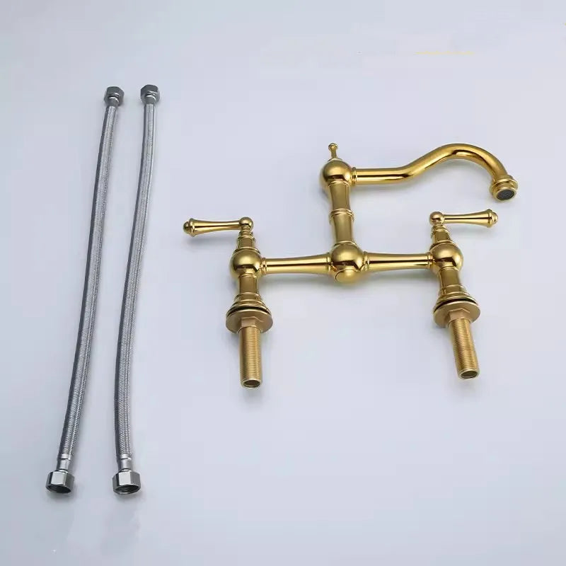 Gold faucet with two flexible hoses on a light gray background