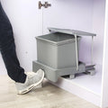 Gray trash bin with a foot pedal mechanism on a white background