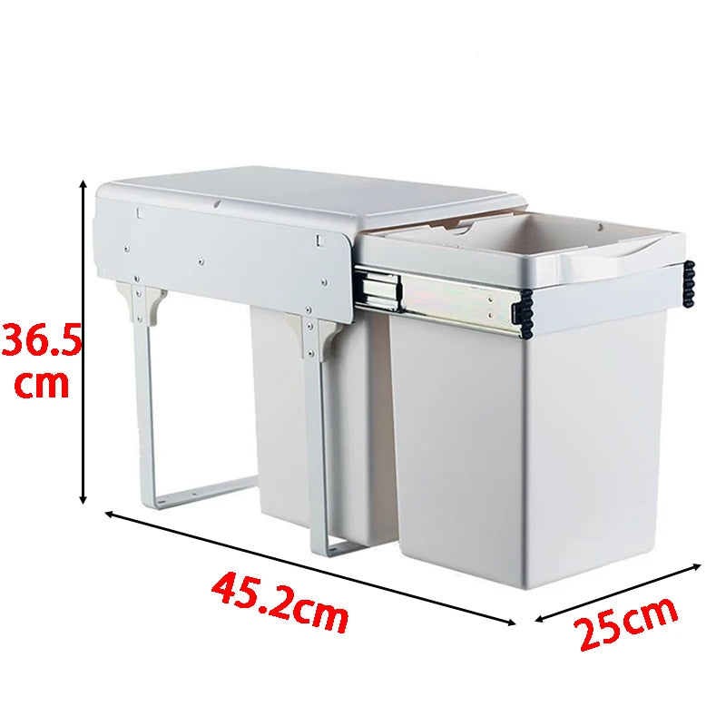 Stainless steel kitchen cabinet with pull-out trash bin and dimensions labeled.