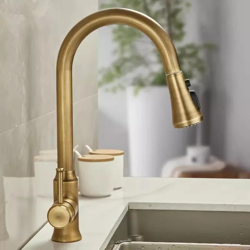 Gold kitchen faucet on a countertop with a blurred background