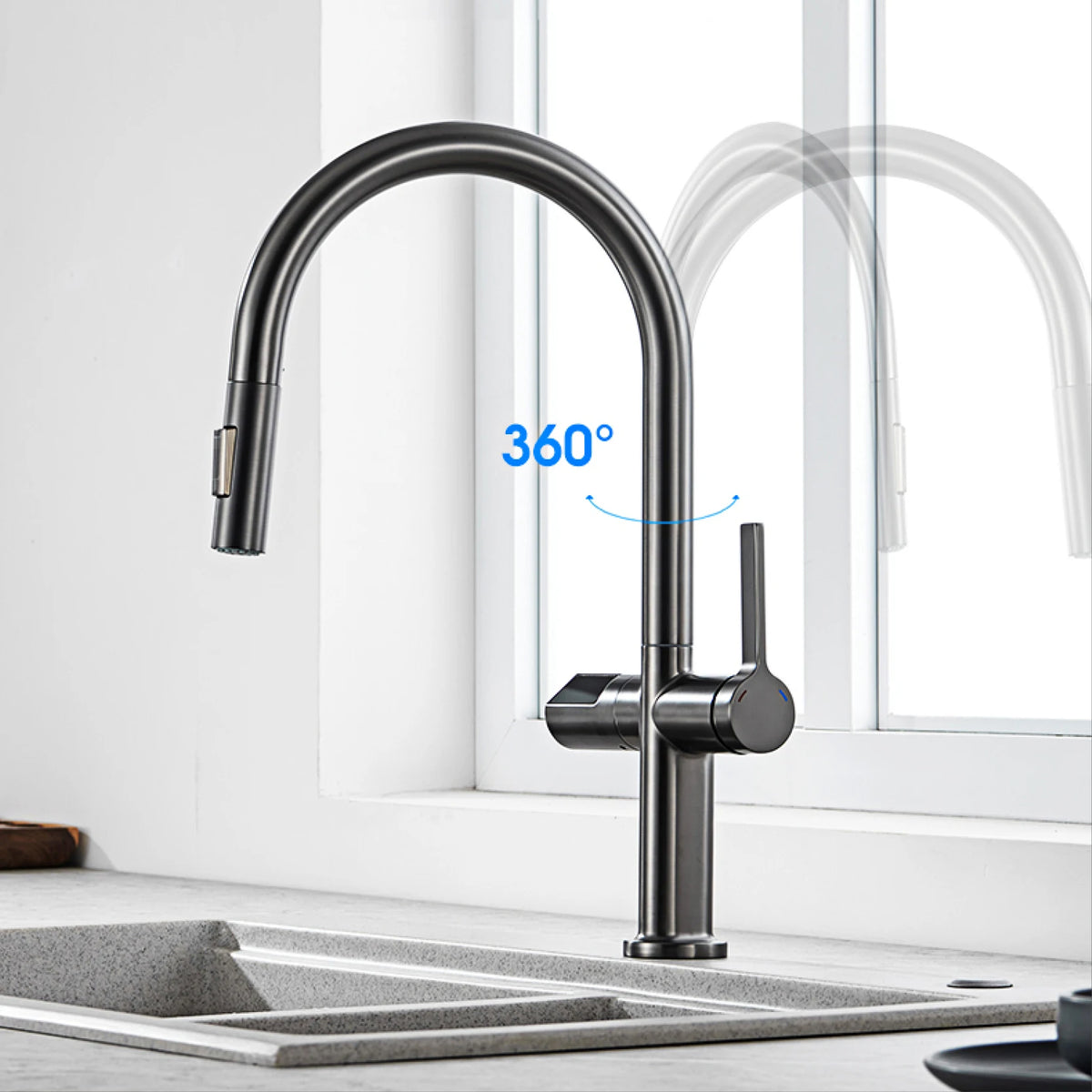 A matte black high-arc pull-down kitchen faucet installed over a gray double-bowl sink, with a bright white window behind it and a blue '360°' graphic indicating swivel range.