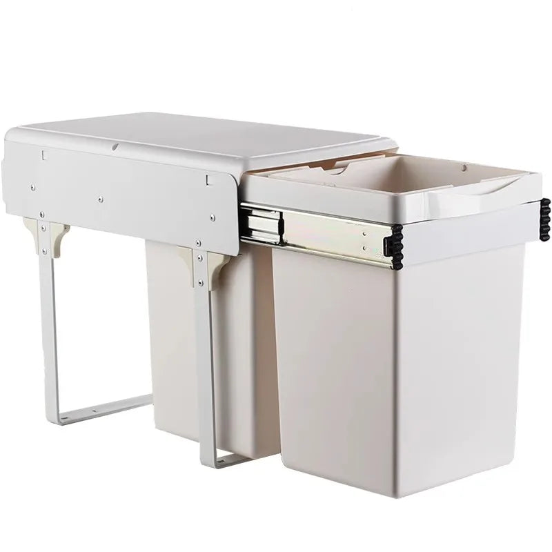 White desk with a pull-out trash can attachment on a white background