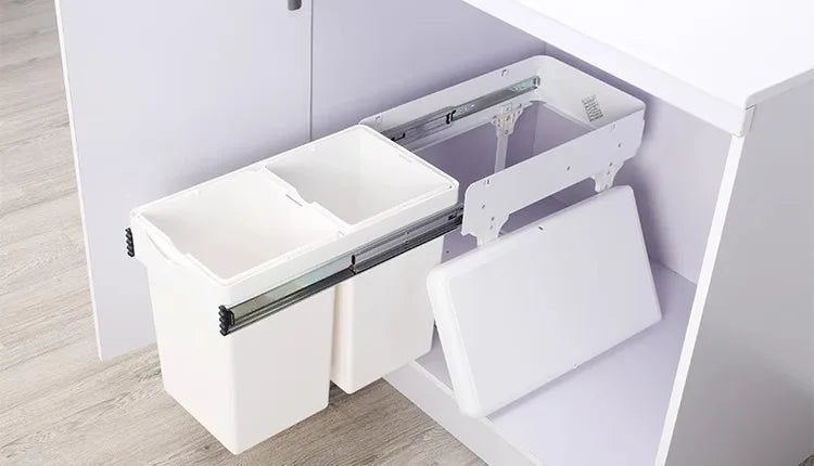 White cabinet with a pull-out drawer mechanism on a light wood floor.