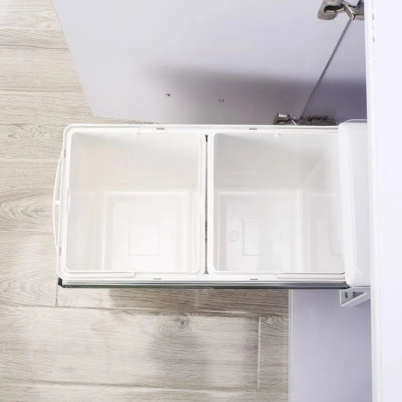 White cabinet with a pull-out drawer on a wooden floor