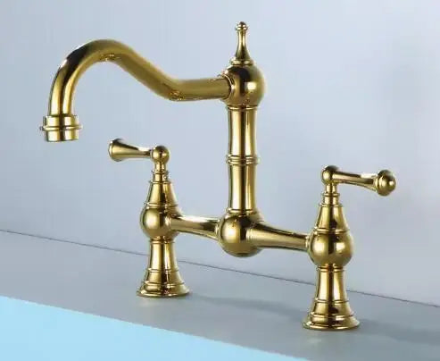 Gold kitchen faucet on a light gray background