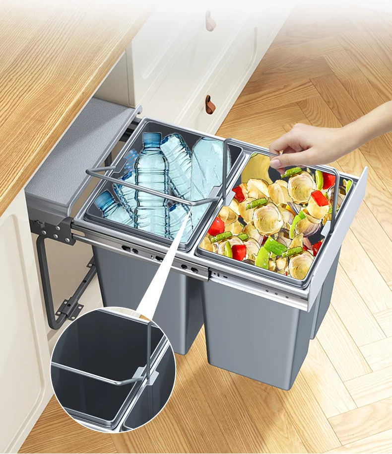 A kitchen scene showing a pull-out dual-compartment trash bin with gray bins, metal rings, and a hand opening the right compartment filled with food waste. Chinese text at the top describes the product, and a circular inset shows a close-up of the metal ring mechanism.
