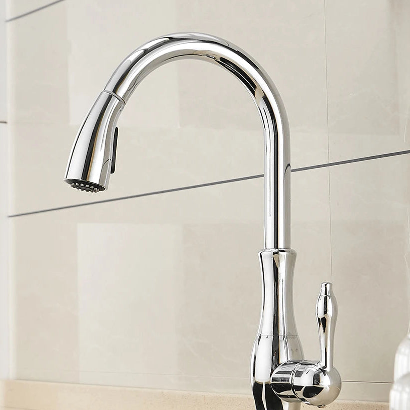 Chrome kitchen faucet mounted on a tiled wall