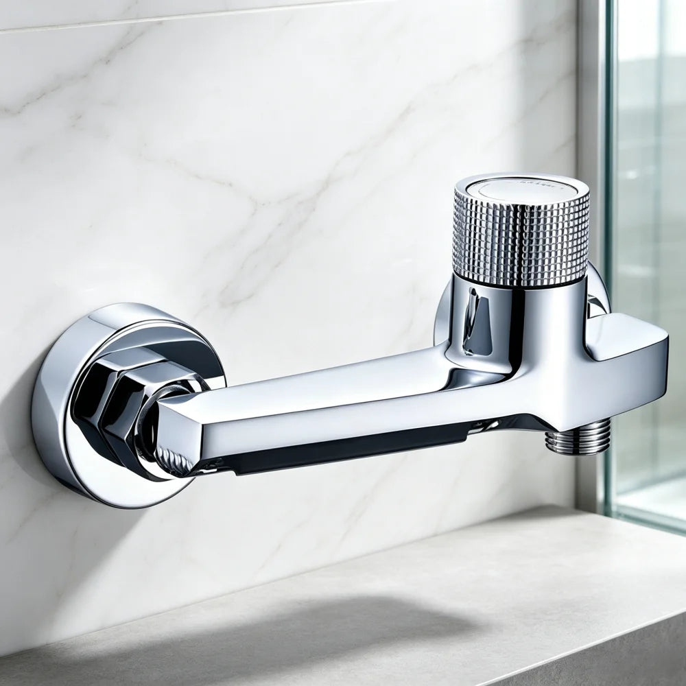 A modern wall-mounted shower arm with a polished chrome finish, mounted on a white marble wall above a shower base.