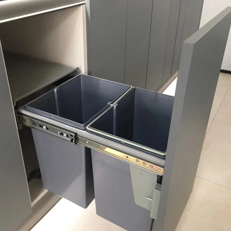 Gray kitchen cabinet with pull-out trash bins