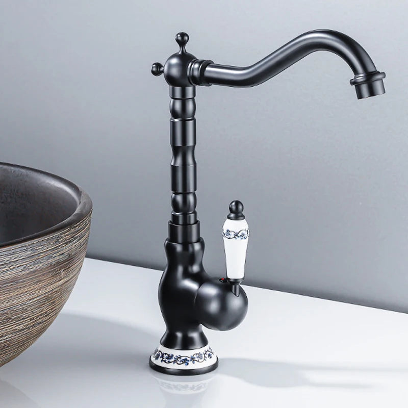Black faucet with decorative elements on a gray background