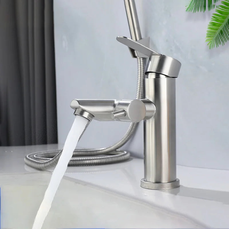 Stainless steel faucet with water flowing in a bathroom setting