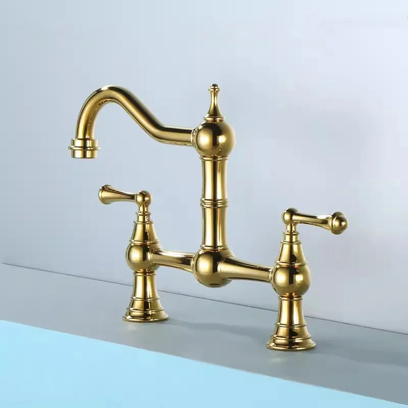 Gold kitchen faucet on a light grey background
