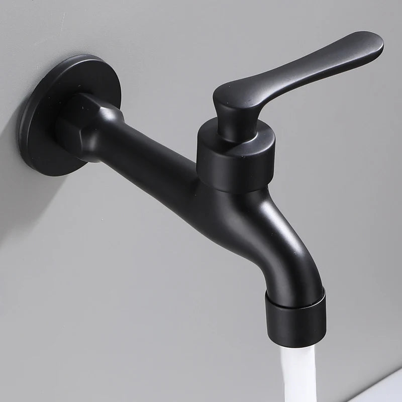 Black wall-mounted faucet on a gray background